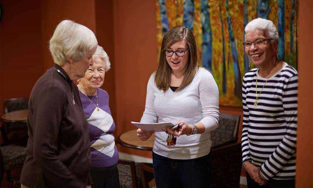 seniors talking to younger woman